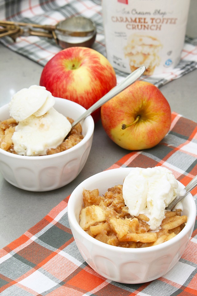 Bowls of slow cooker apple crisp topped with ice cream.
