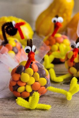 Candy filled turkey treats for Thanksgiving using M&Ms, pipe cleaners, and tulle.