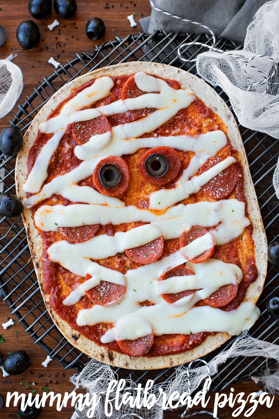 Mummy flatbread pizza with pepperoni and mozerella cheese.