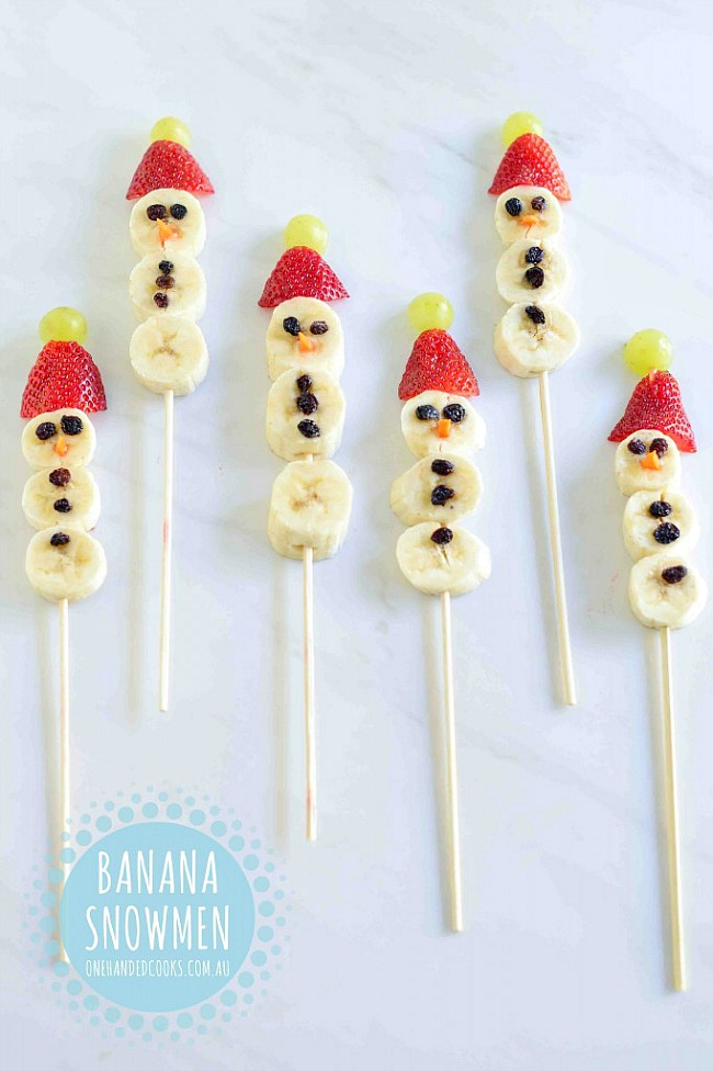 Fun and healthy Christmas snack ideas. Banana snowmen on a stick with strawberry hats.