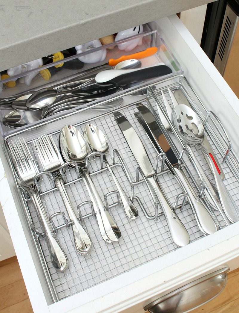 Organized utensil drawer with silver utensil holder.