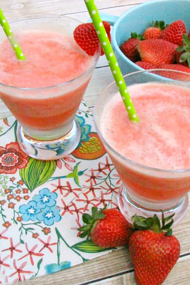 Strawberry frozen slush drinks in two cups.