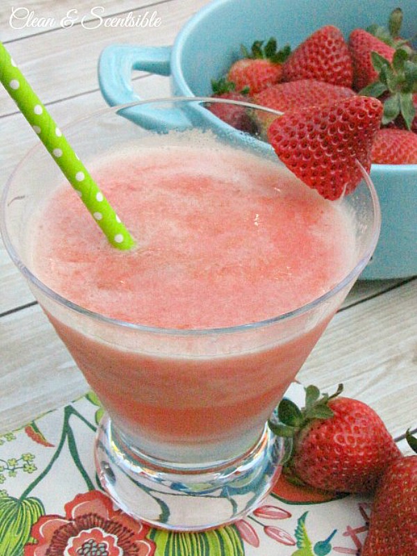 Strawberry frozen slushie drink with a fresh strawberry for garnish.