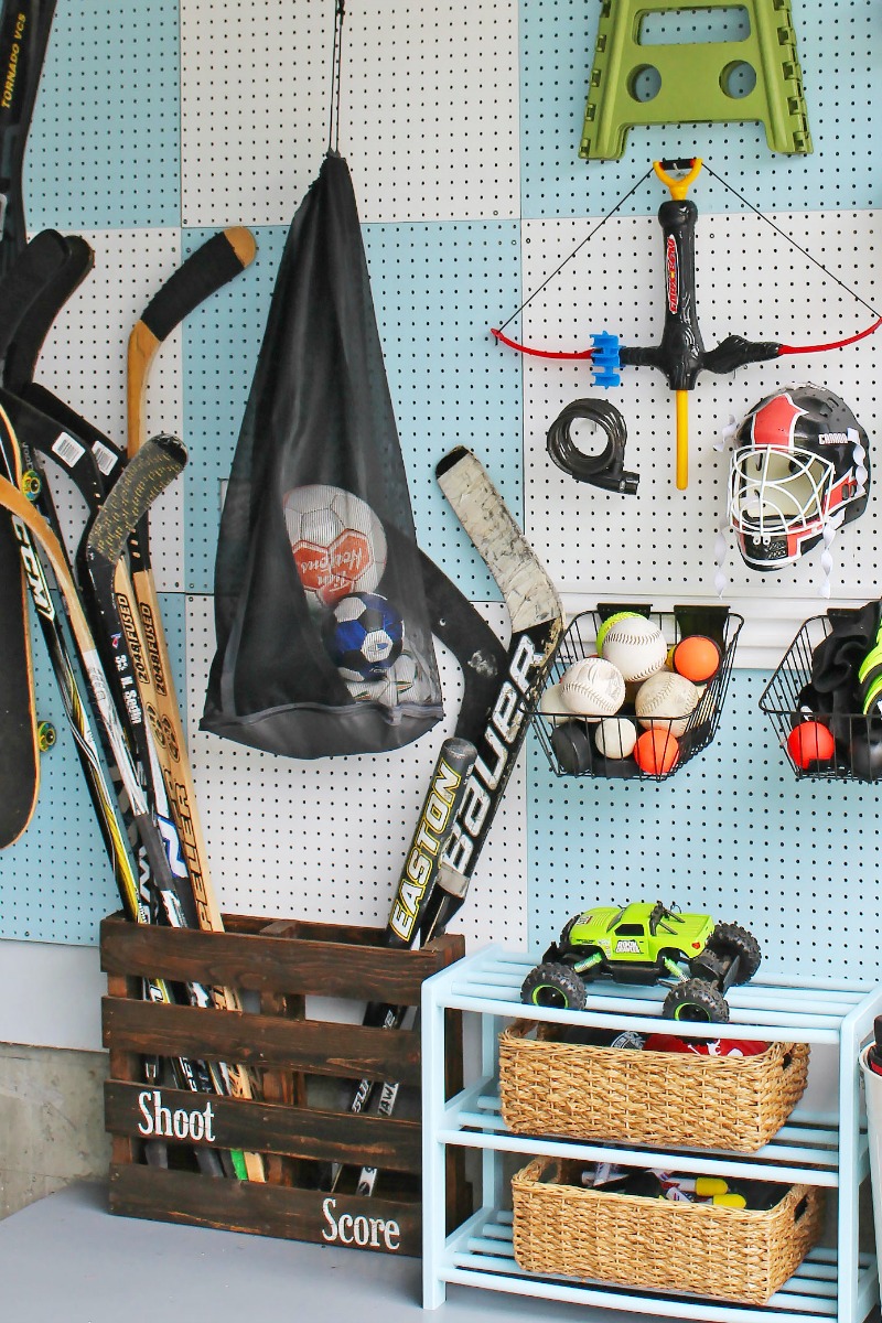Blue and white checked pegboard organizer for sports equipment.