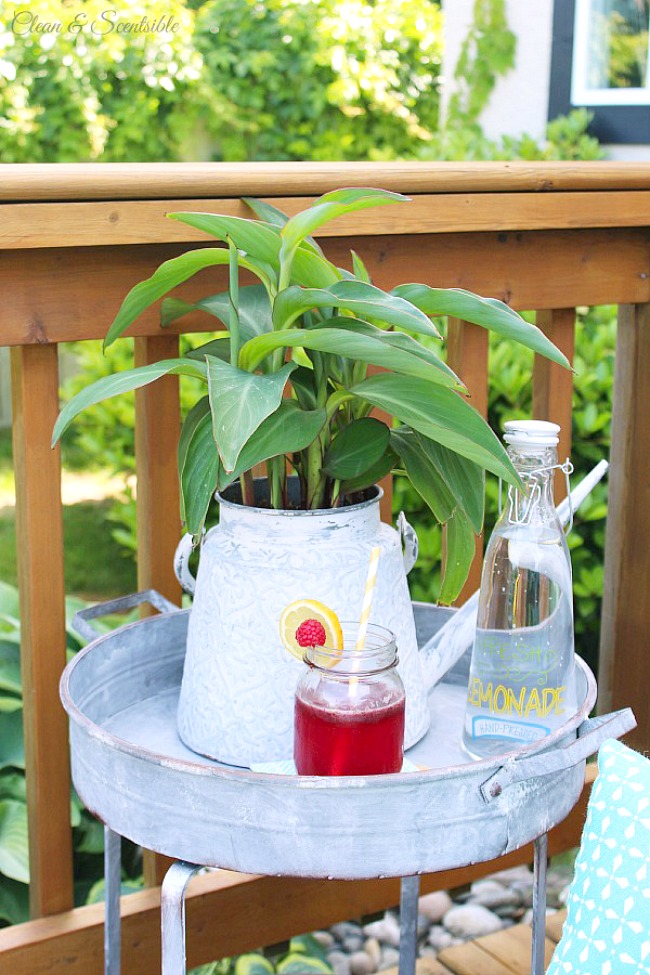 Strawberry lemonade in a mason jar on a galvanized metal side table.