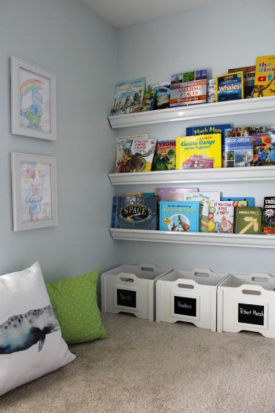 Love this cute reading nook! Encourage your kids to read with a comfy space and books that are easily accessible.