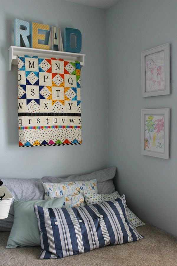 Love this cute reading nook!  Encourage your kids to read with a comfy space and books that are easily accessible.