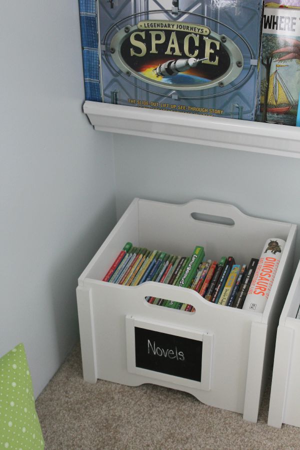 Love this cute reading nook!  Encourage your kids to read with a comfy space and books that are easily accessible.