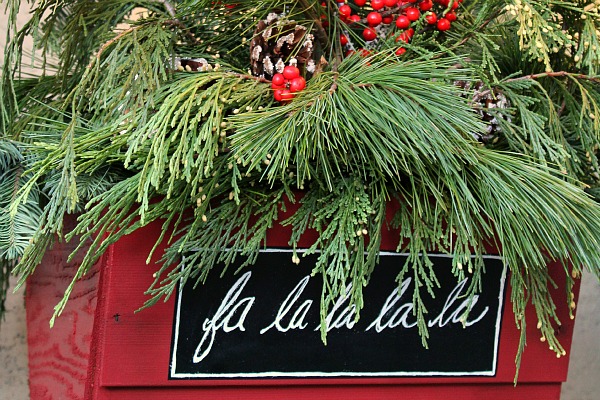 Pretty rustic Christmas hanging baskets with fresh greenery. 