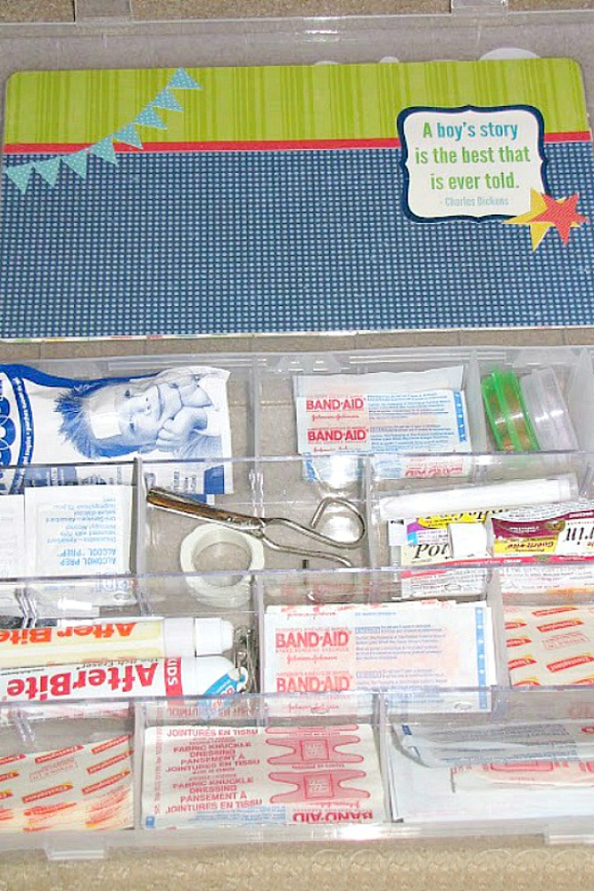 Organized first aid kit using a craft supply storage container.