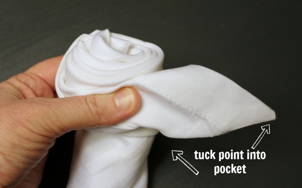 How to fold a napkin into a rose bud.