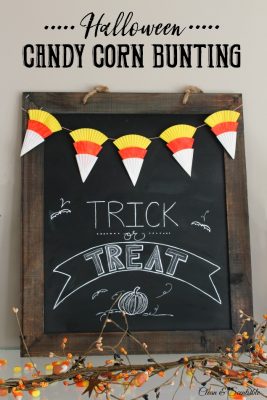 Candy corn bunting made from cupcake liners on a Halloween chalkboard.