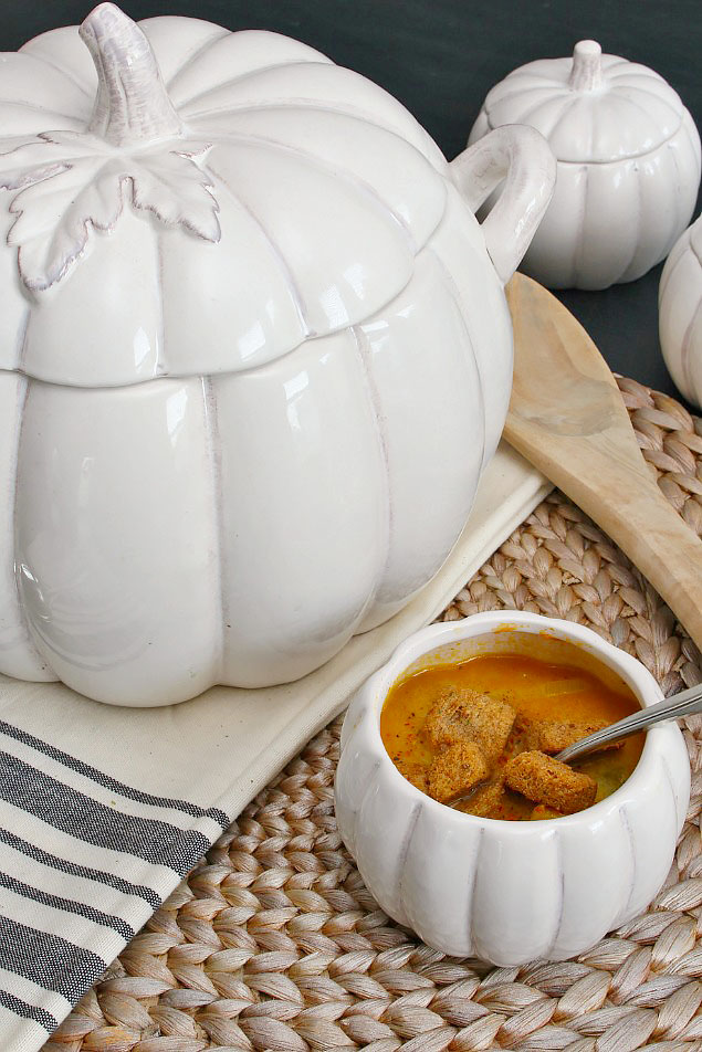 Pumpkin soup served in a white pumpkin tureen.