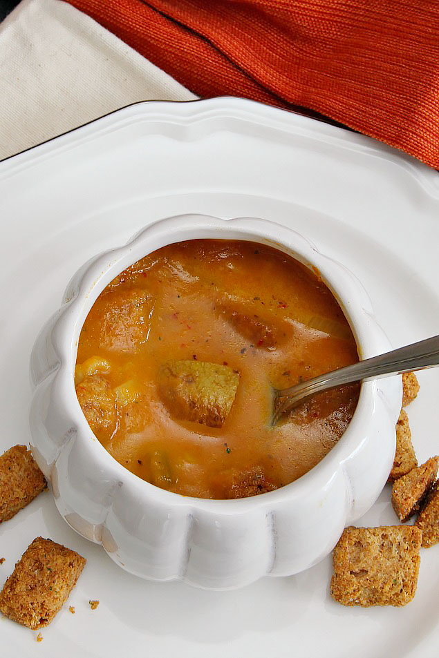 Pumpkin soup in a white pumpkin bowl.