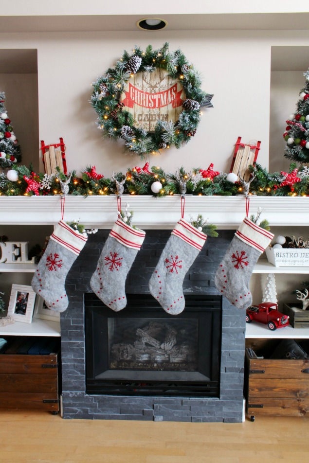 Cozy Christmas cabin Christmas mantel - snowy covered branches with red and white.