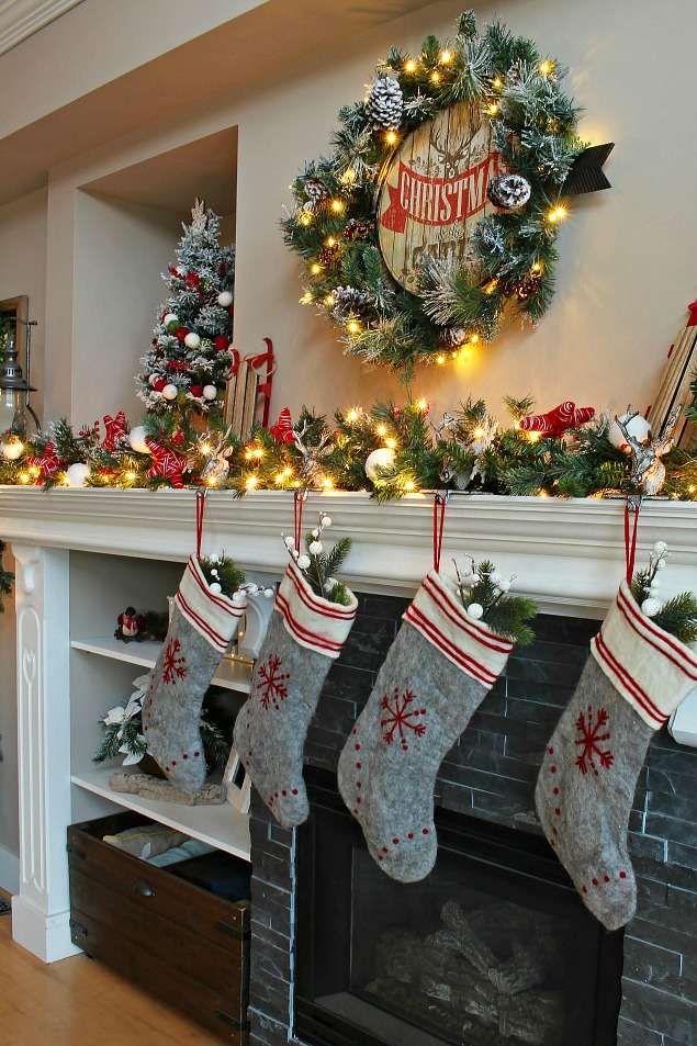 Cozy Christmas cabin Christmas mantel - snowy covered branches with red and white.