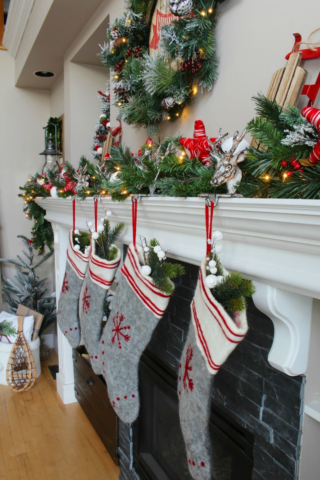 Cozy Christmas cabin Chirstmas mantel - snowy covered branches with red and white.
