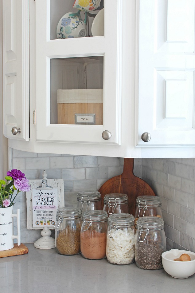Organized glass jars used for kitchen food storage.