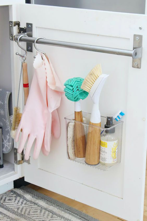 Use a towel bar or adhesive containers to attach to inside to kitchen cupboards for extra storage.