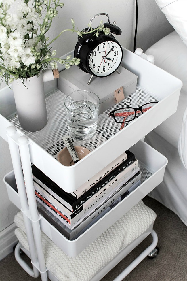 Use a rolling cart for a creative and practical bedside table. Very inexpensive but it's so pretty when styled with all of your favorite things.