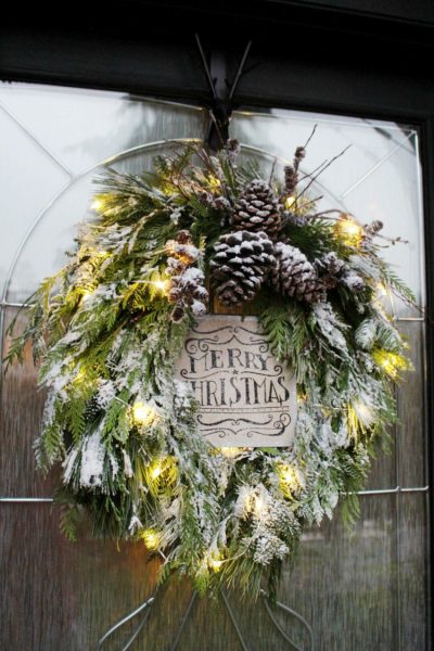 Fresh Christmas wreath with flocking. Remove the Christmas sign and it will last all winter!