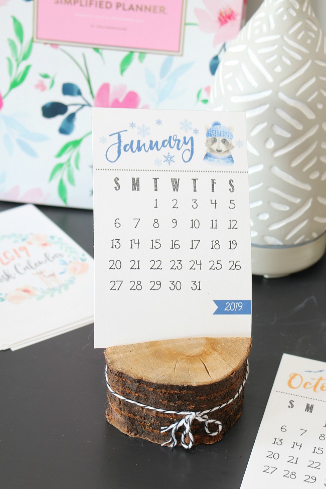 Free printable calendar in a wood slice holder.