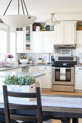 White farmhouse style kitchen with quartz countertops.