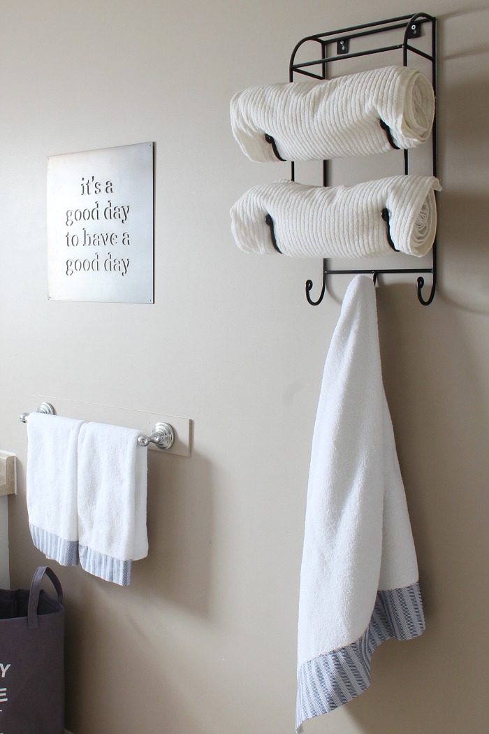 White towel hanging from towel hooks.