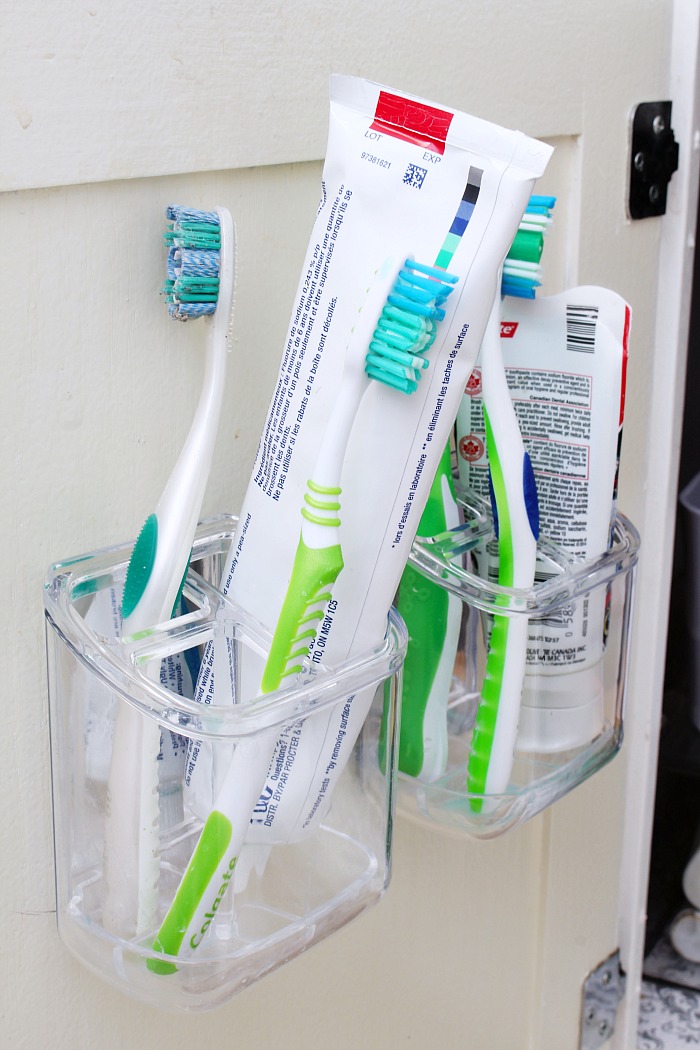 Toothbrush holders from InterDesign that attached on the inside of bathroom cabinet door.