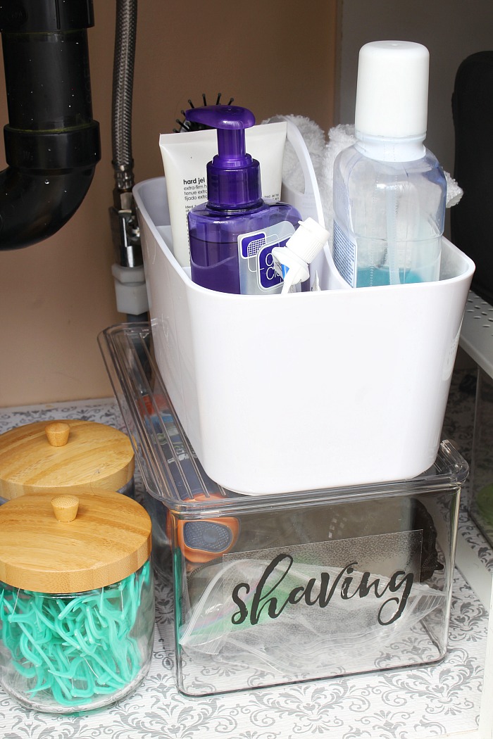 Organized bathroom cabinet with labeled storage.