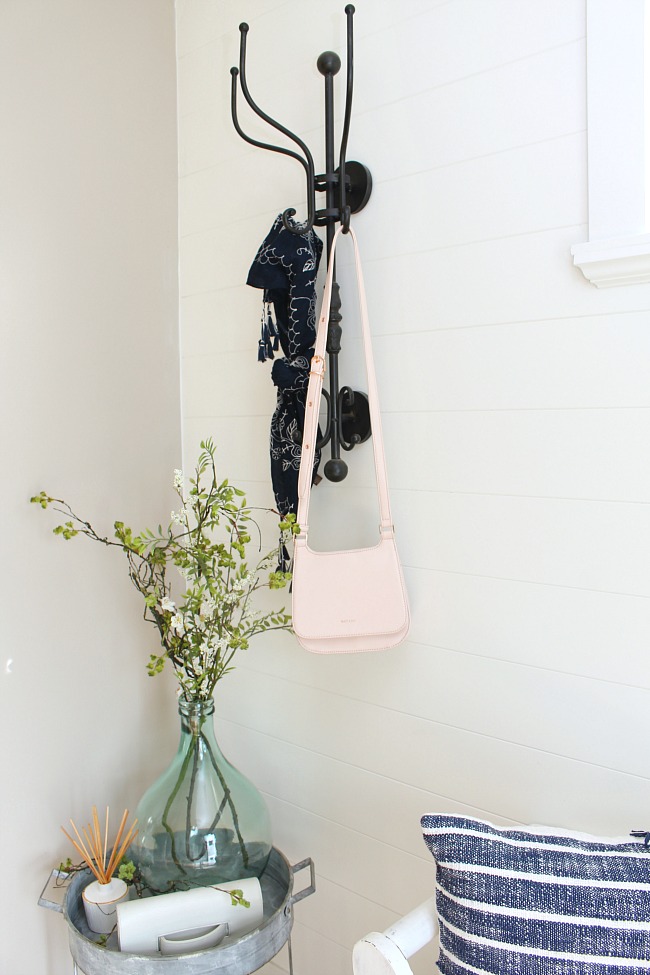 Spring front entryway with iron coat hanger.