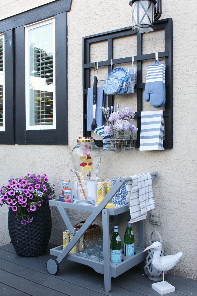 Outdoor drink station with styled beverage cart.