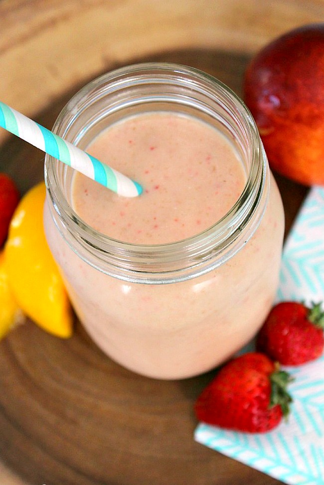 Peach and strawberry smoothie in a mason jar.
