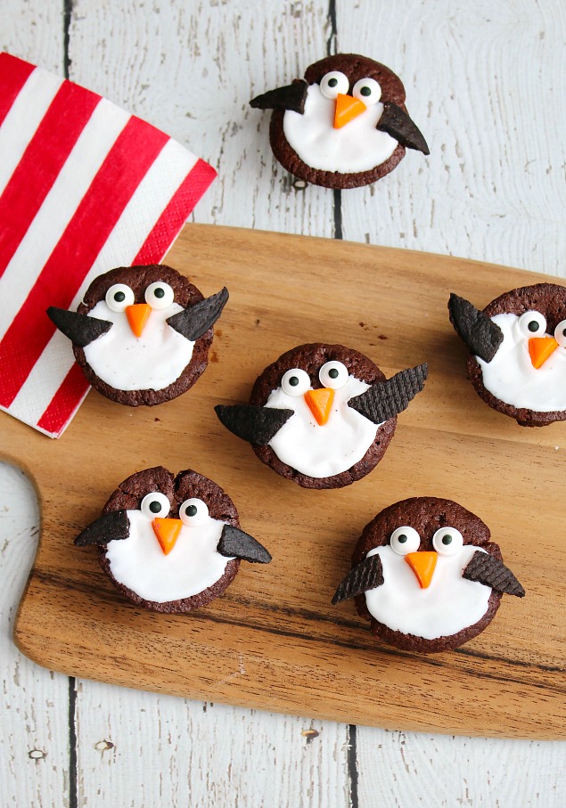 Cute penguin brownies made from two-bite brownies, cookie wafers, and icing.