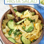 Cucumber, corn, and herb pasta salad in a coconut bowl.