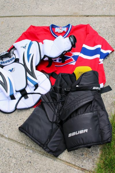 How to clean sports gear. Variety of hockey equipment waiting for cleaning.