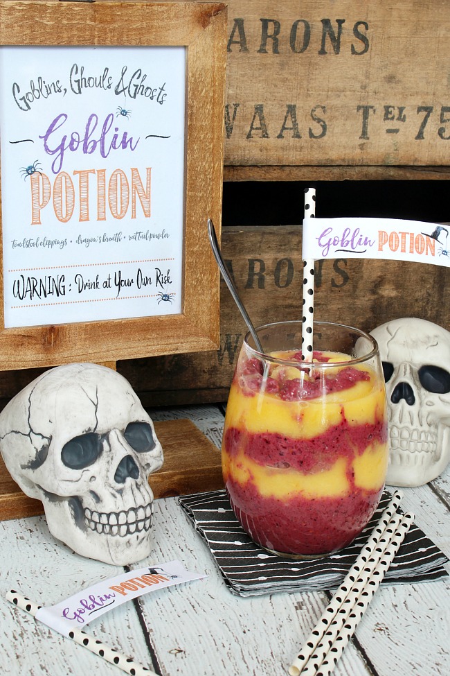 Halloween smoothie with a goblin potion straw topper and free Goblin Potion Halloween printable.