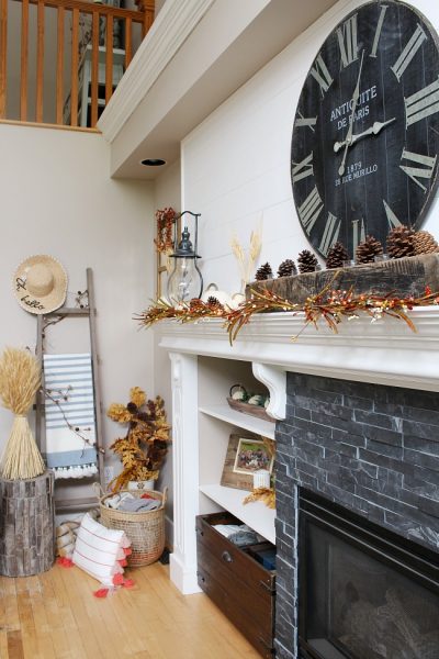 White mantel with faux shiplap decorated for fall. Traditional fall colors, mini-lights and natural elements.