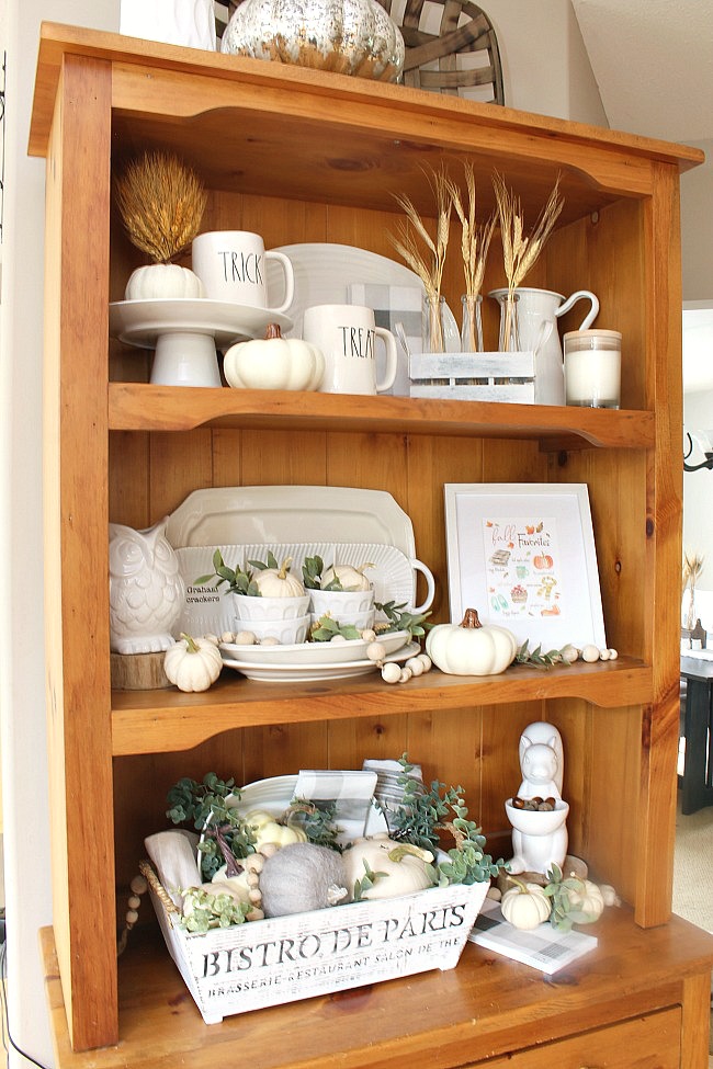 Wood hutch decorated for fall with white pumpkins and greenery. Includes a free fall printable.