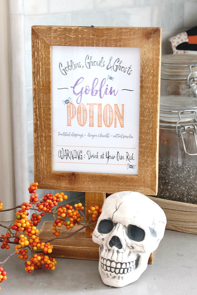 Goblin potion Halloween printable in a wooden frame.