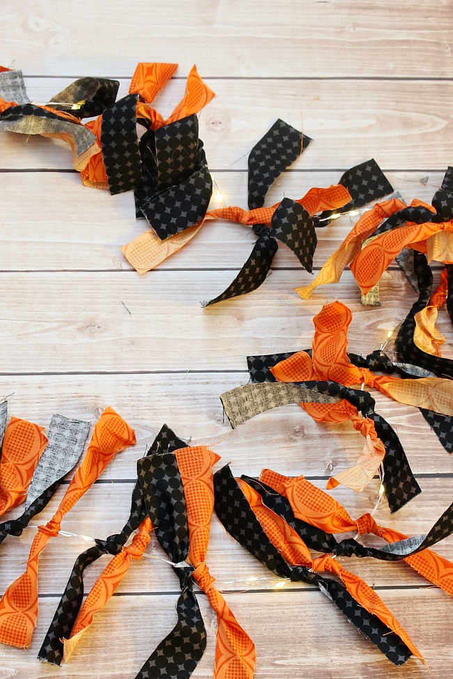 Cute DIY Halloween garland made from scrap fabric and a string of lights.