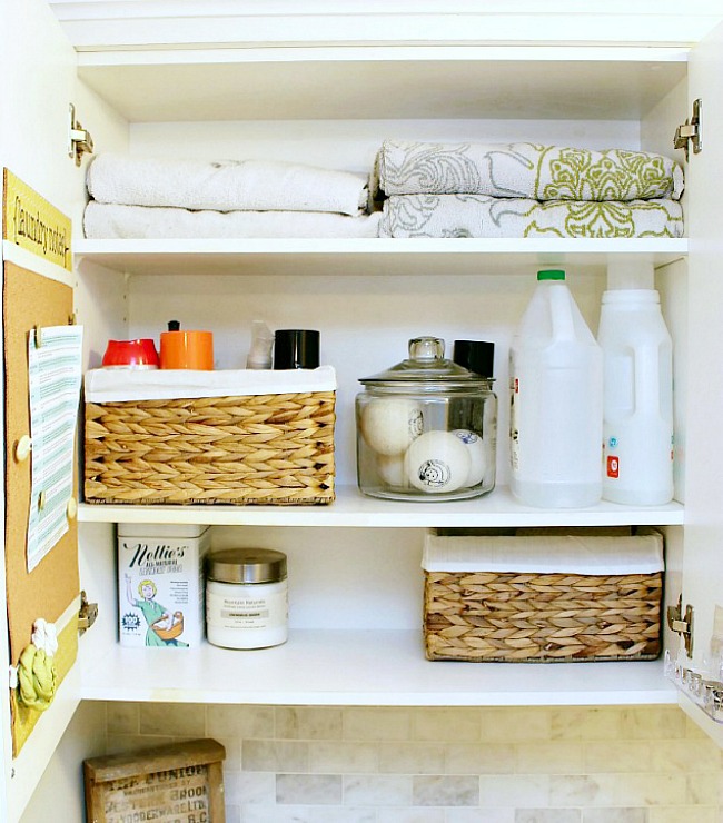 Organized laundry cupboard with stain removal guide.