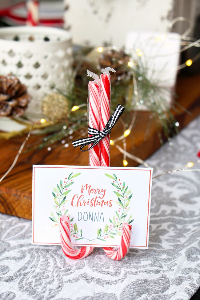 Free printable watercolor Christmas placecard on DIY candy cane place card holder.