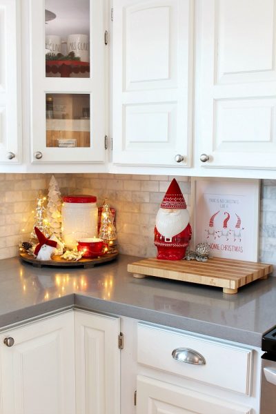 White kitchen with cute Christmas gnome cookie jar all decorated for Christmas in red and white.