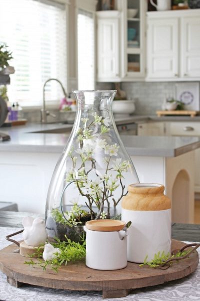 Pretty spring terrarium centerpiece on a wood tray.