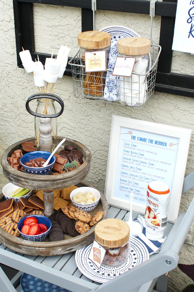 Cute s'mores bar display with tiered tray and free s'mores printables.