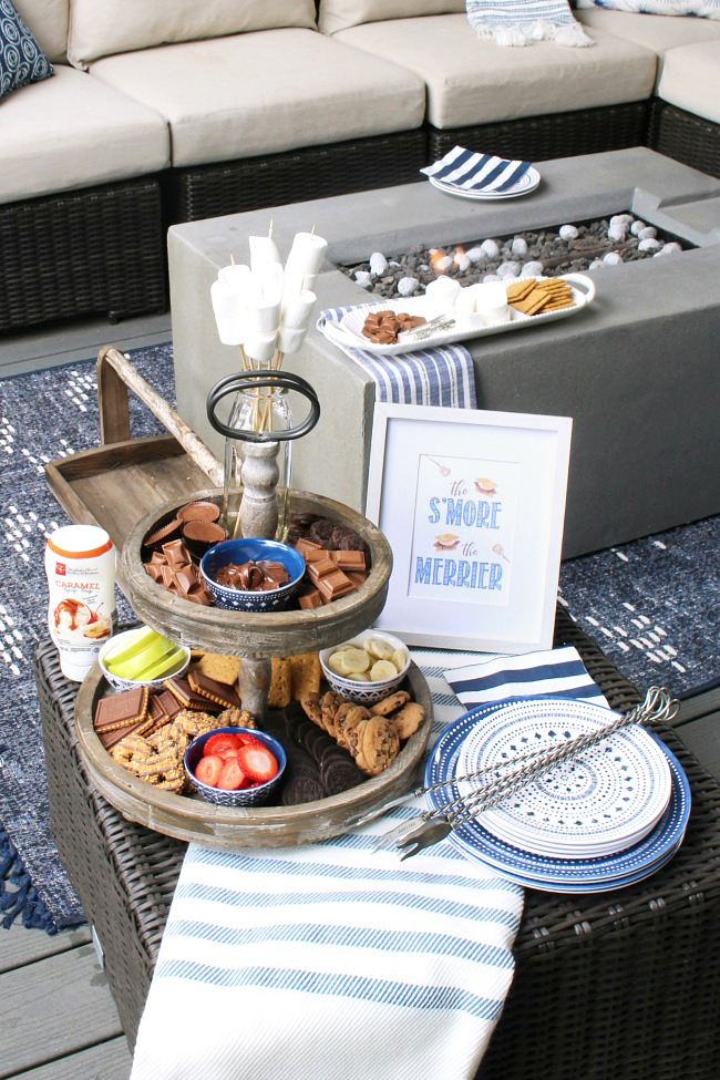 Cute s'mores bar display with tiered tray and free s'mores printables.