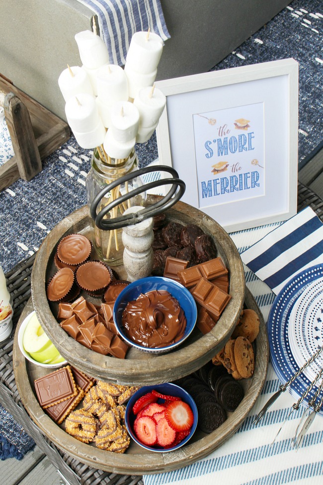 Cute DIY s'mores bar on a tiered tray with s'mores recipes.