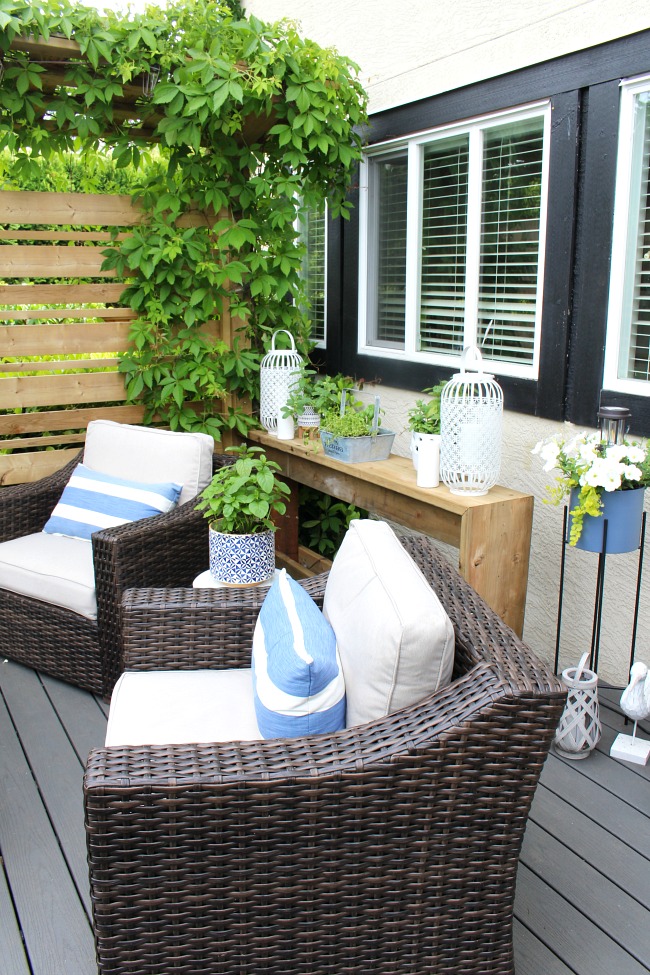 Beautiful outdoor sitting area on a backyard patio. Resin furniture with pops of blue.