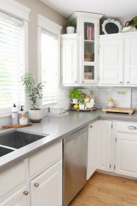 White farmhouse style kitchen with simple summer decor.